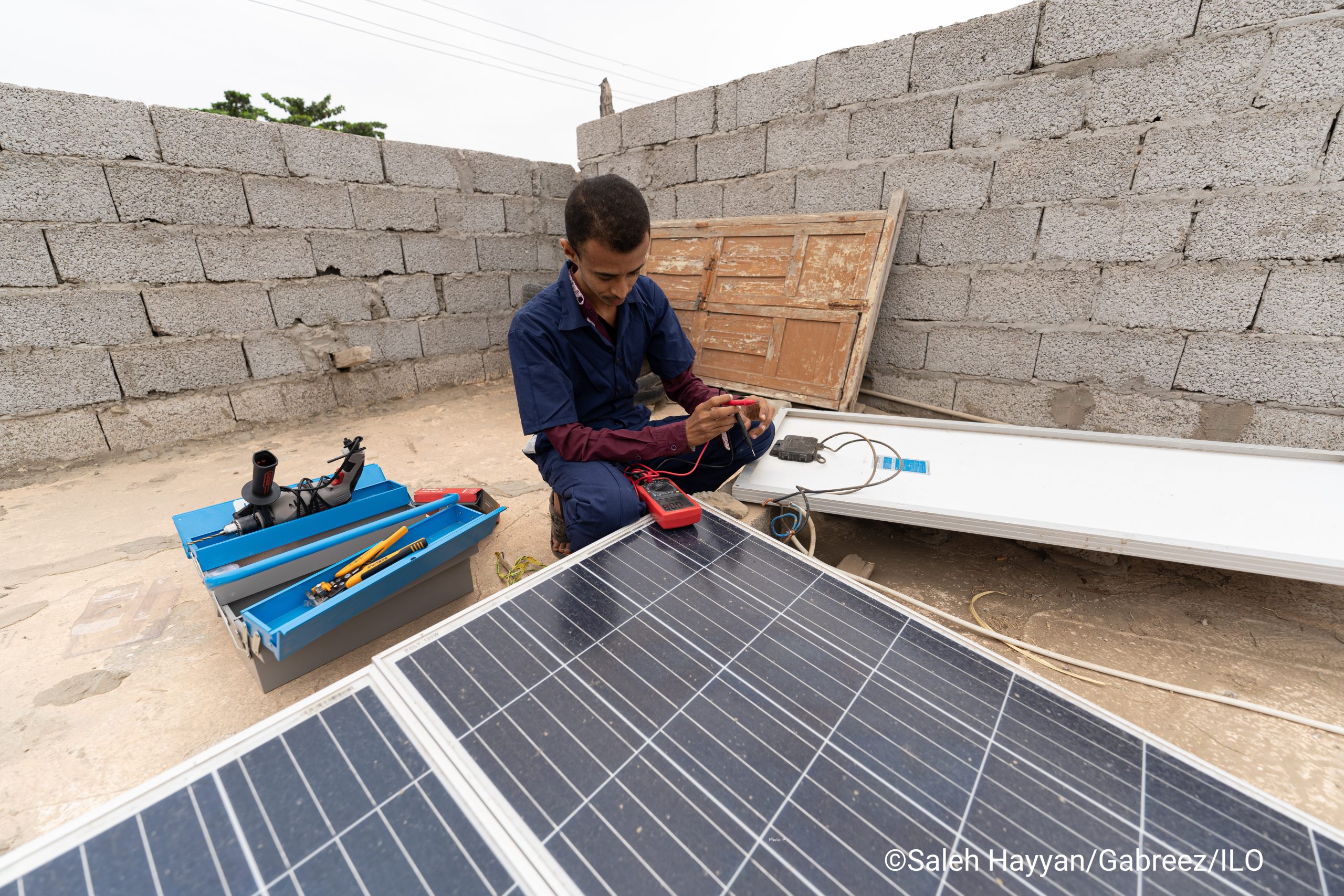 person working on solar panels