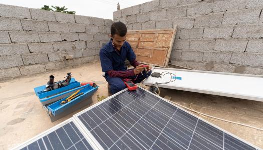 person working on solar panels